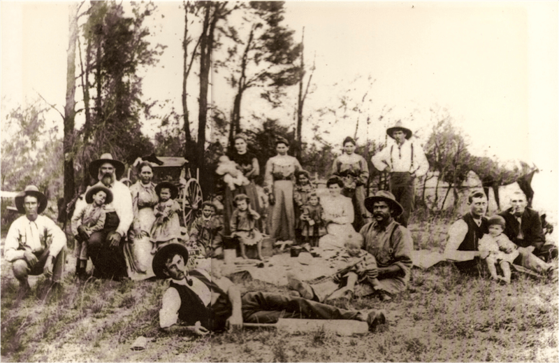Old sepia photo of the Ruttley family standing in the Pilliga scrub.