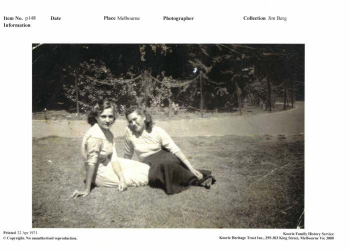 Black and white photo of Alma Thorpe at 13, sitting on the grass with her cousin Dotty Lovett 